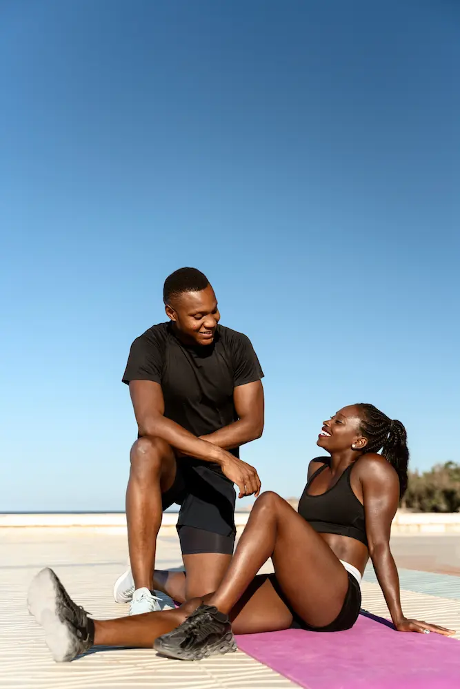 Beautiful-young-cheerful-couple-talking - Finding Peace Counseling Service PLLC Beautiful young cheerful couple talking while resting after workout at the beach
