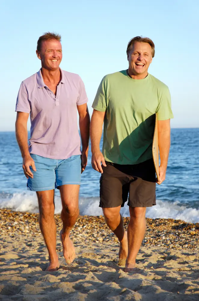 Happy-gay-couple-on-beach - Finding Peace Counseling Service PLLC Happy gay couple on beach