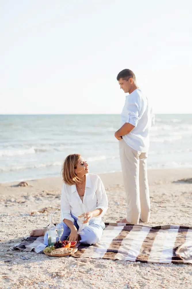 Happy-romantic-middle-aged-couple-on-the-beach - Finding Peace Counseling Service PLLC Happy romantic middle aged couple on the beach. Picnic by the sea.