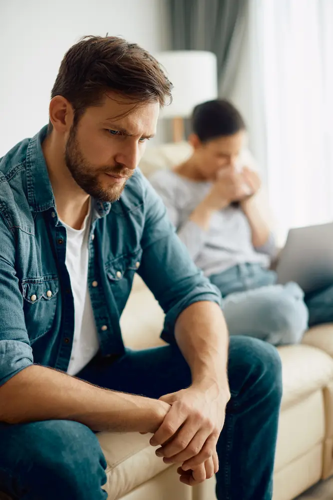 Worried-man-thinking-of-relationship-difficulties - Finding Peace Counseling Service PLLC Worried man thinking of relationship difficulties he has with his wife at home.