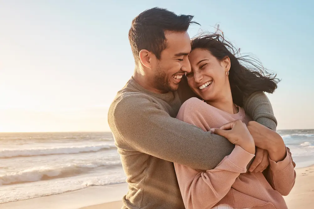 Young-diverse-biracial-couple-having-fun - Finding Peace Counseling Service PLLC Young diverse biracial couple having fun at the beach together.