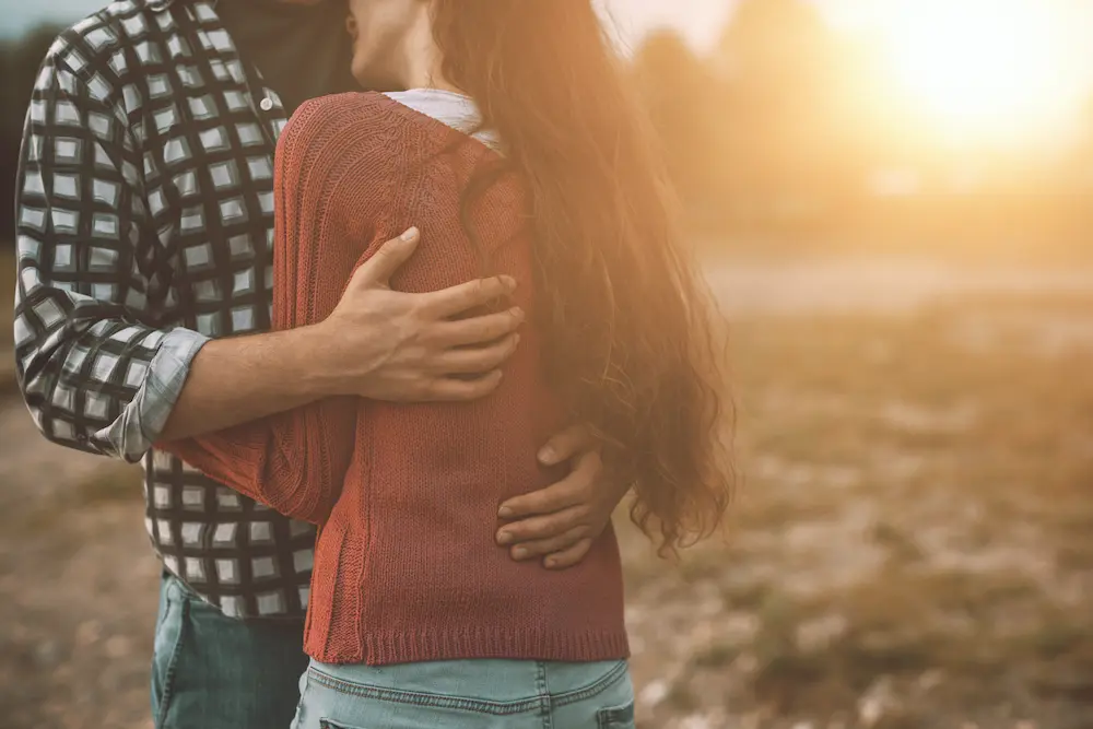 Young loving couple hugging outdoors