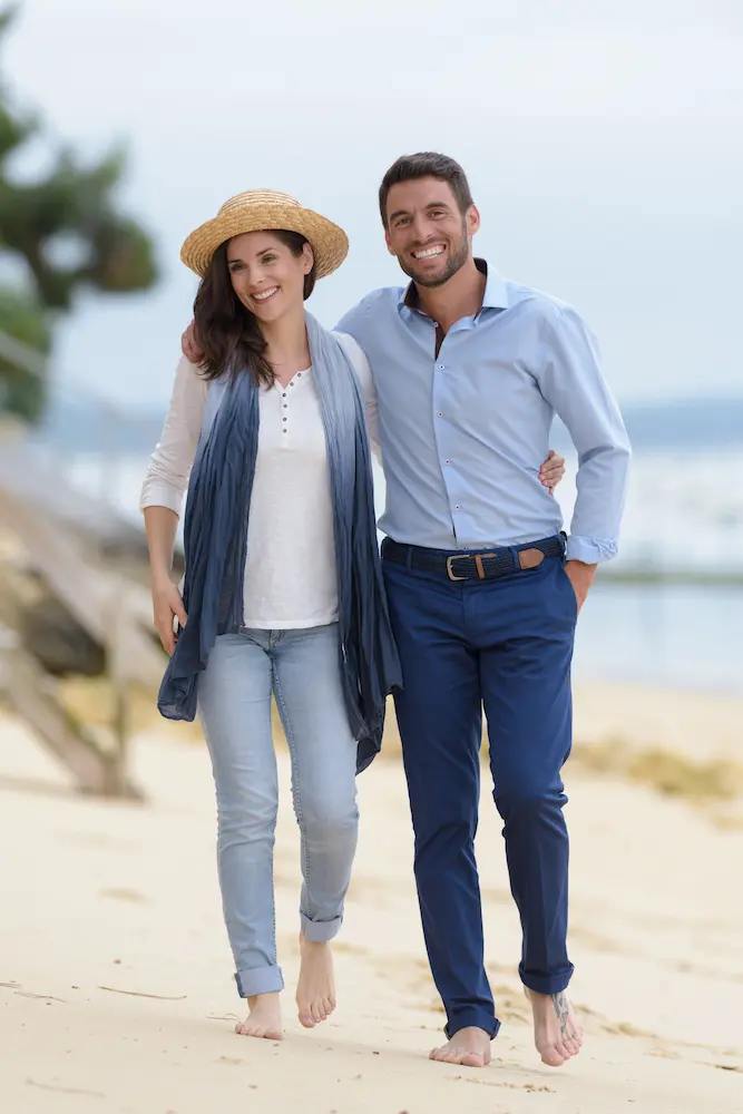 mid-adult-couple-walking-barefoot-along-the-beach - Finding Peace Counseling Service PLLC mid-adult couple walking barefoot along the beach