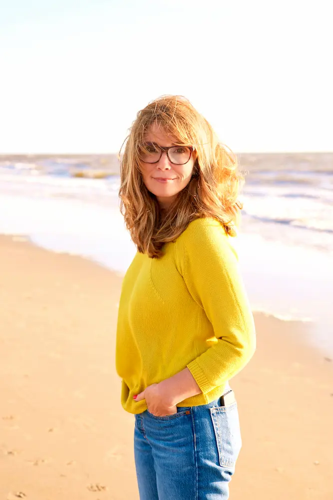 woman-with-frizzy-hair-walking-on-the-beach - Finding Peace Counseling Service PLLC Middle aged woman with frizzy hair walking on the beach
