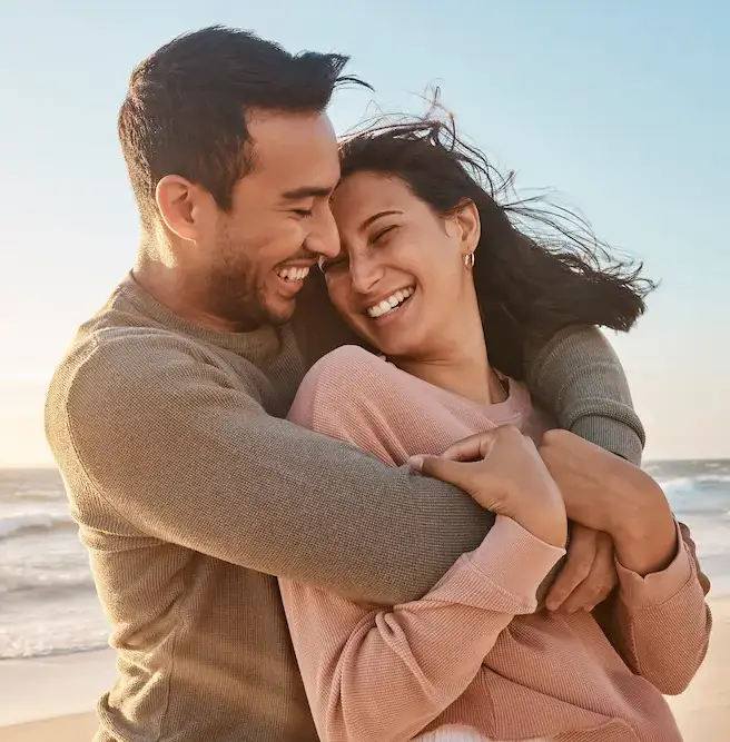 Young diverse biracial couple having fun at the beach together.